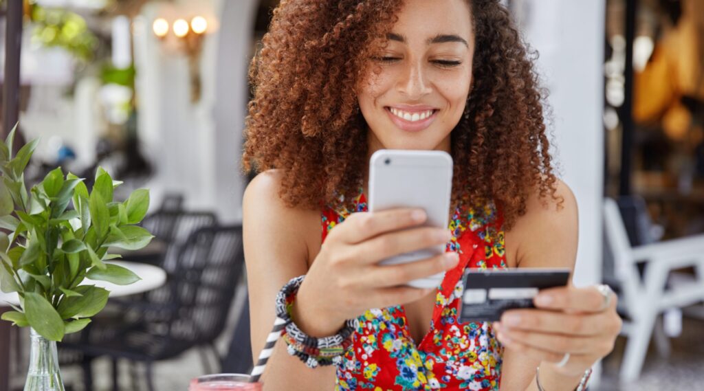 woman with smartphone and banking card